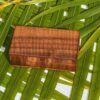 A wooden box sitting on top of a palm tree.