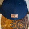 A hat with a leather patch on it.